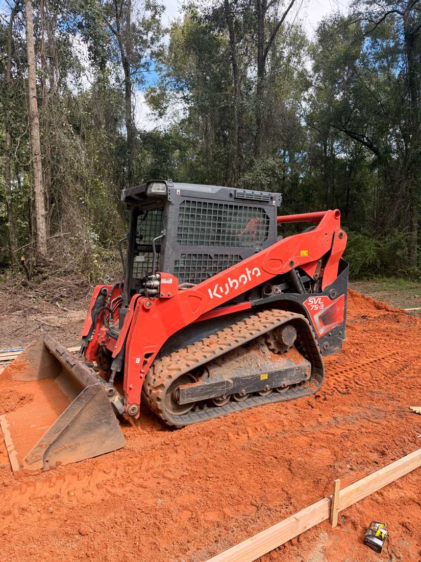 Red Kubota SVL75-3 with bucket on red dirt